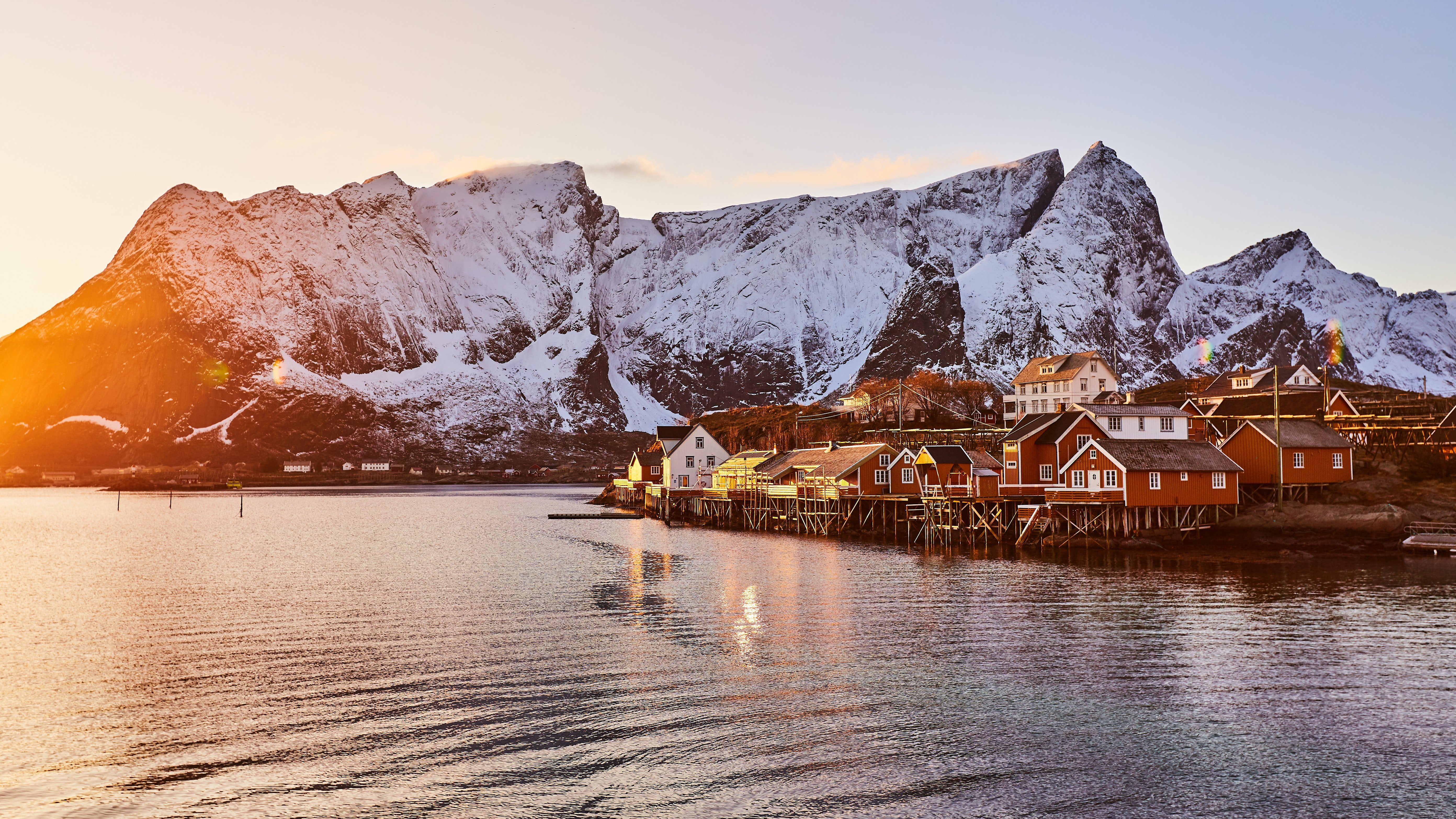 sunlight on a small Norwegian village and mountains 