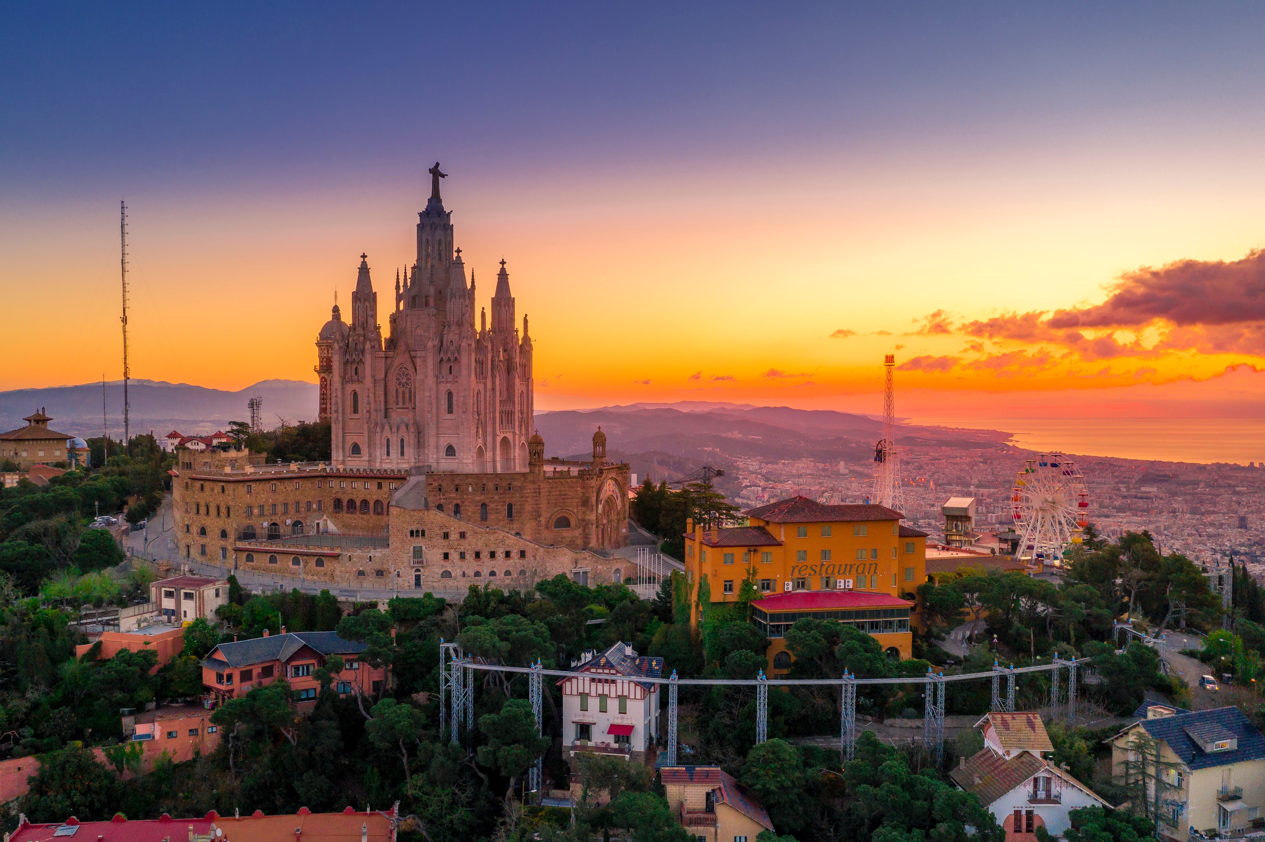 a view of Barcelona city in Spain with an orange sunset.