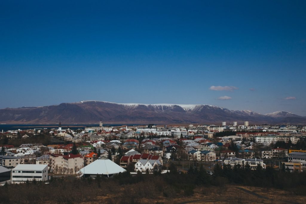 houses infront of a mountain with snow on top and blue skies while remote work in winter