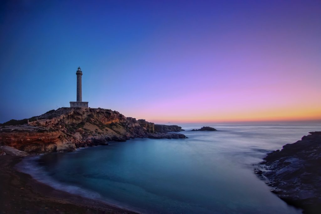 beautiful sunrise with a lighthouse by the coast for remote work in winter