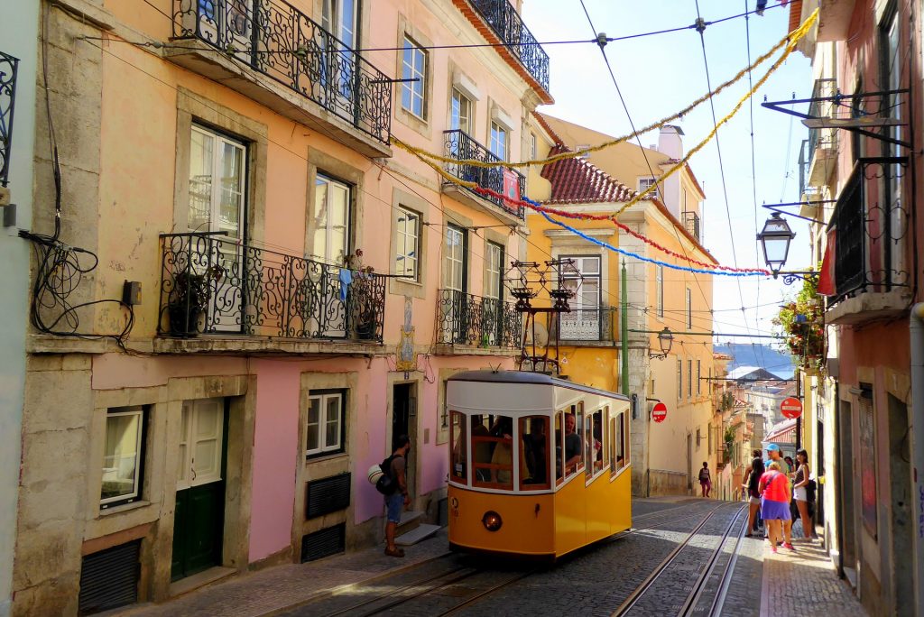 one of the best cities to live in for young professionals is in Lisbon with a yellow tram.