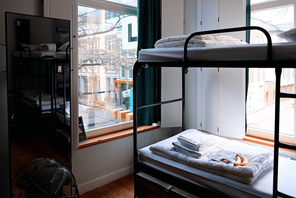 a picture of bunk beds in a hostel in a city which is perfect accommodation for a short trip