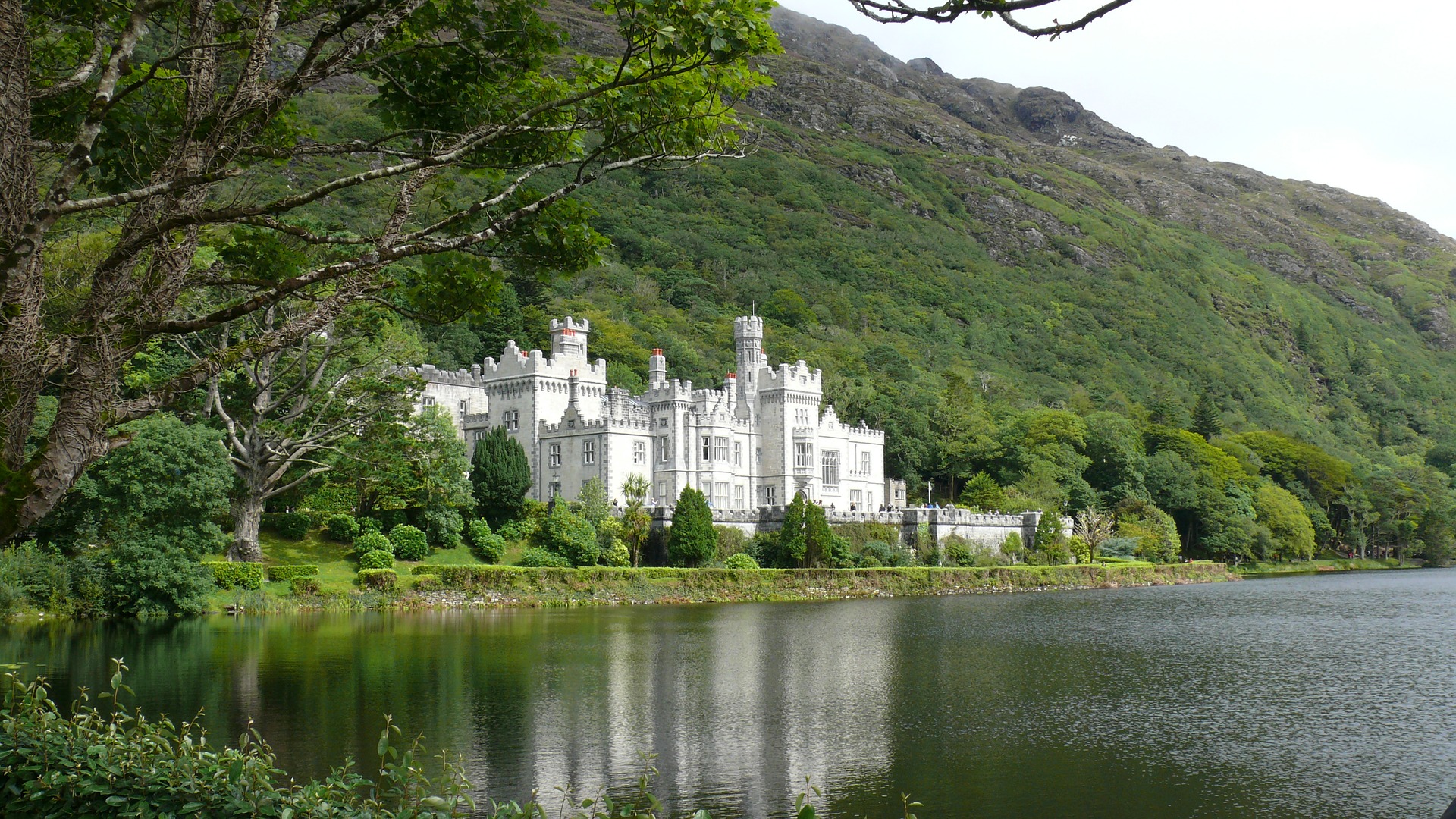 The white Kylemore palace against green Irish landscape