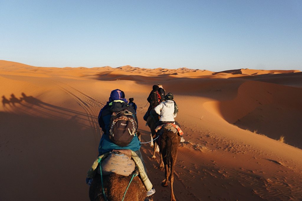 Riding into the sunset of the Sahara on camelback