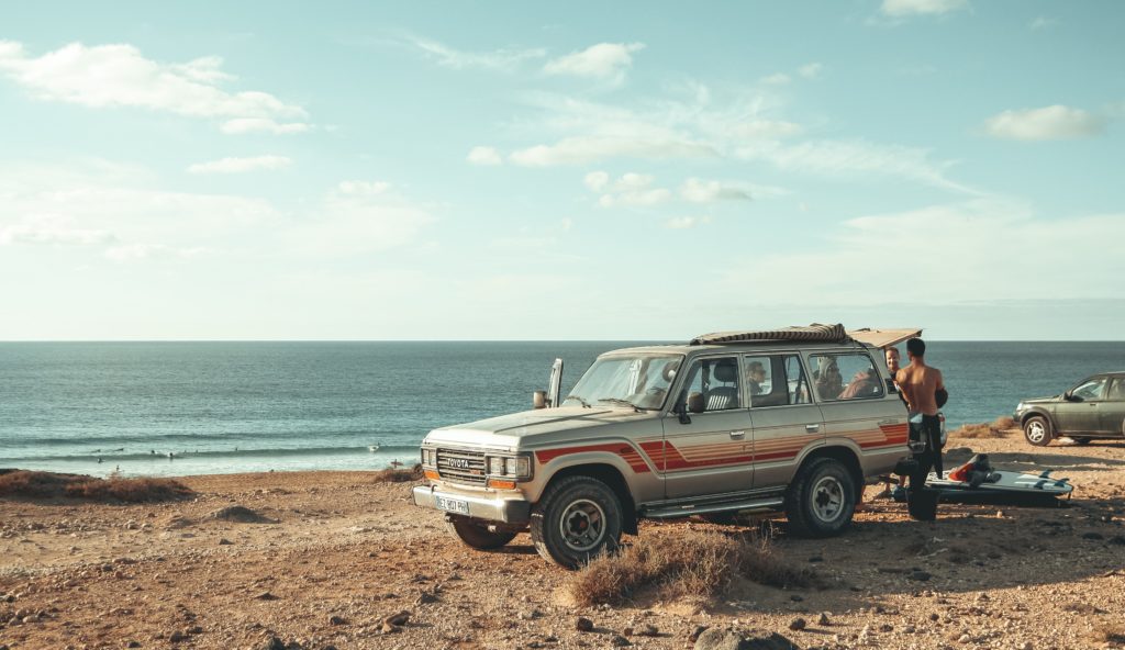 a car with two men by the sea side