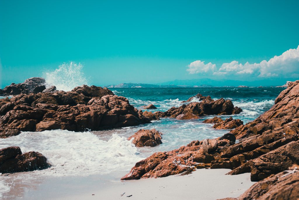 Waves crashing against rocks on the beaches of La Maddalena