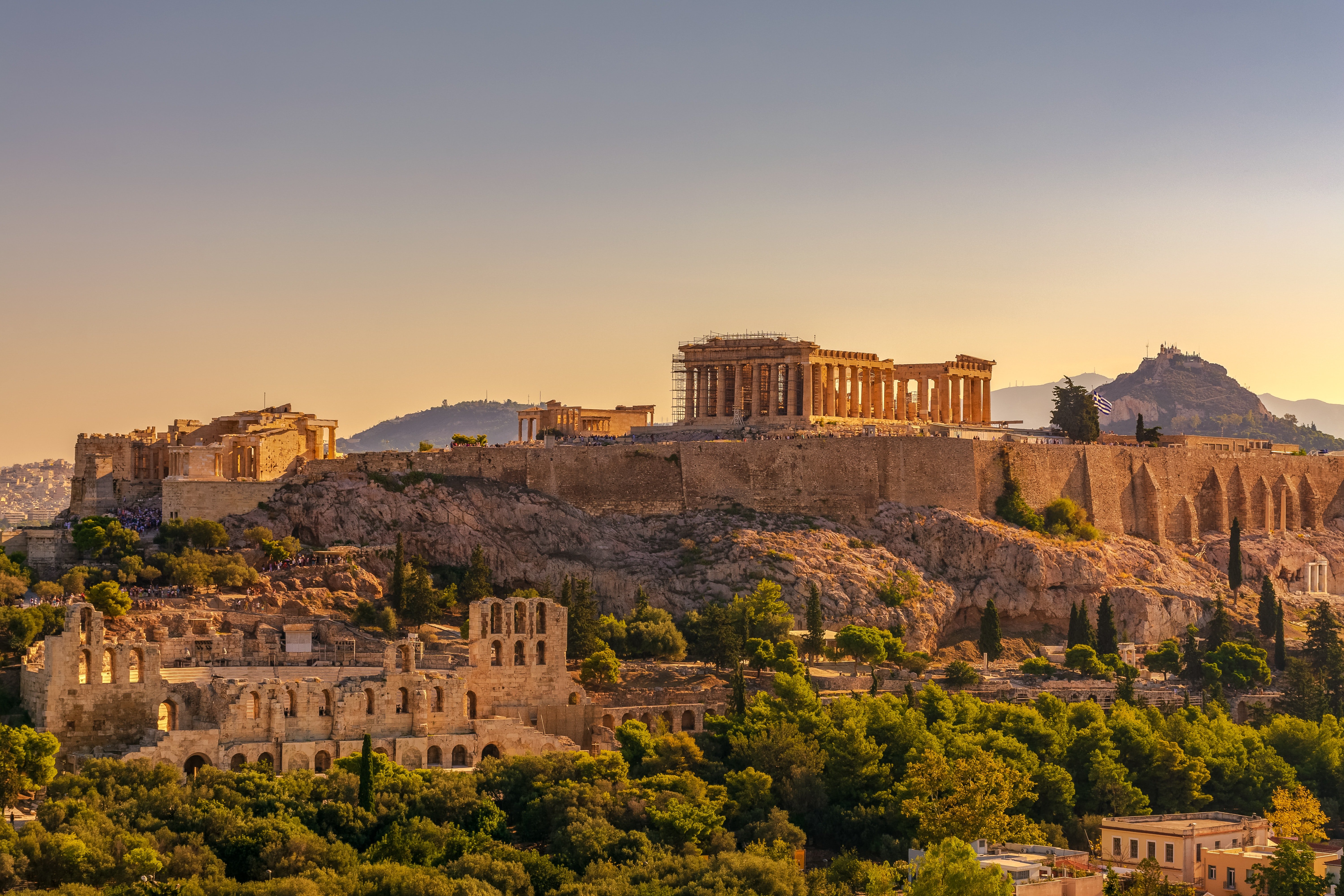 The ancient Acropolis on top of a hill in Athens at sunrise